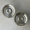 Undersides of two Duchin weighted sterling silver candlesticks, showing circular bases with stamped maker's marks.