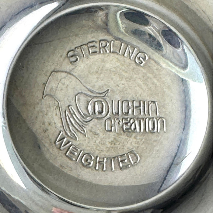 Close-up of the underside maker's mark reading Sterling, Duchin Creation, and Weighted, with a stylized maker's emblem.