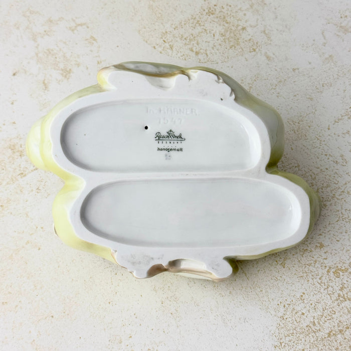 Underside of the porcelain duck pair showing two recessed base areas, an impressed designer signature and model number, and the printed Rosenthal Germany backstamp.