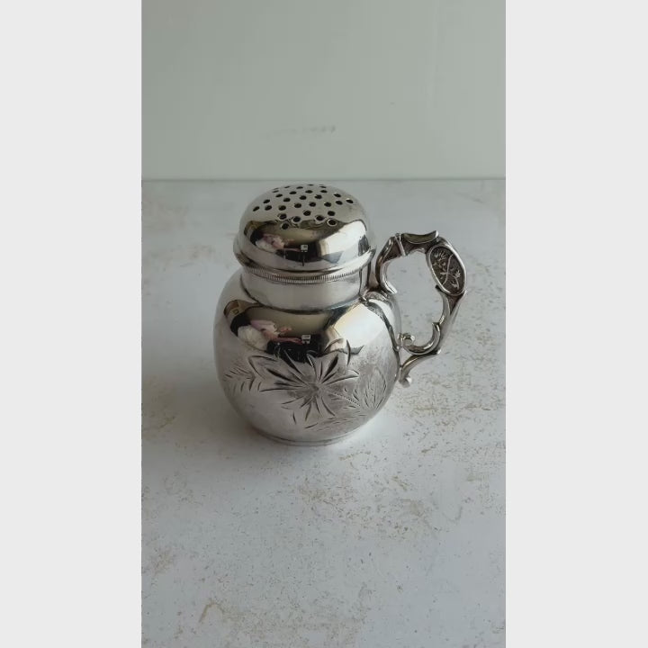 Short video showing silver sugar shaker lid being unscrewed, inside of shaker, underside of shaker, and inside of shaker lid