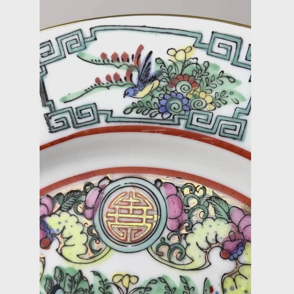 Vintage export porcelain plate showing close-up the birds, peonies, butterflies, and longevity medallions in pink, turquoise green, and iron red around the border