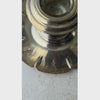 Close-up video of pair of vintage silverplate candlestick holders showing low scalloped bases, flared stems, and geometric Art Deco decoration and then transitioning to front profile view.