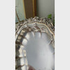 Close-up video of vintage International Silverplate bowl showing its fluted body and ornate raised floral and scroll border.