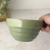 Vintage Over and Back green yellow ware bowl with stepped sides and exposed yellowware rim rotated by hand to show interior and then profile