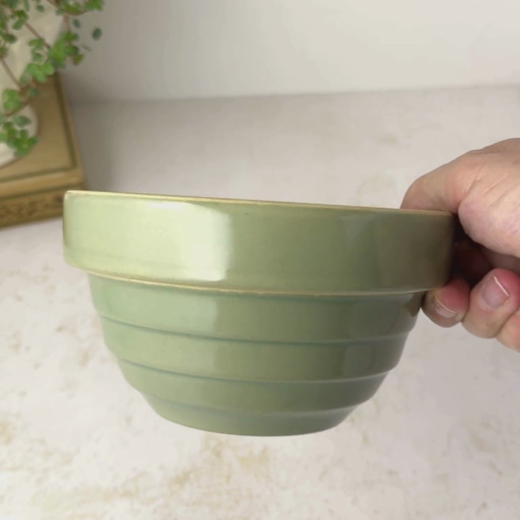 Vintage Over and Back green yellow ware bowl with stepped sides and exposed yellowware rim rotated by hand to show interior and then profile