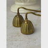 Pair of vintage brass candle snuffers shown from ribbed bell-shaped heads along the long twisted handles to the ball handle ends