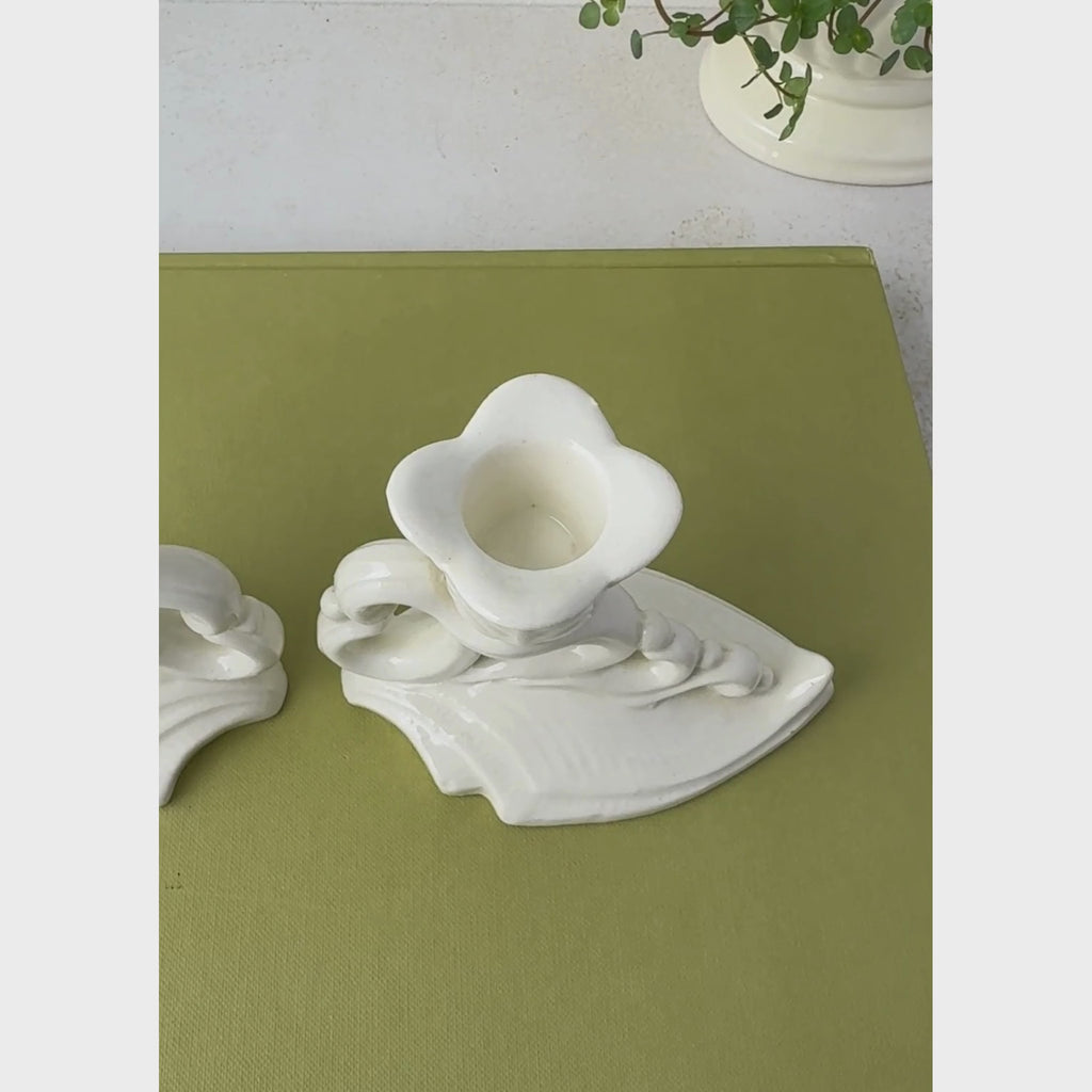 Close-up of off-white Art Deco ceramic candle holder panning from overhead to profile view