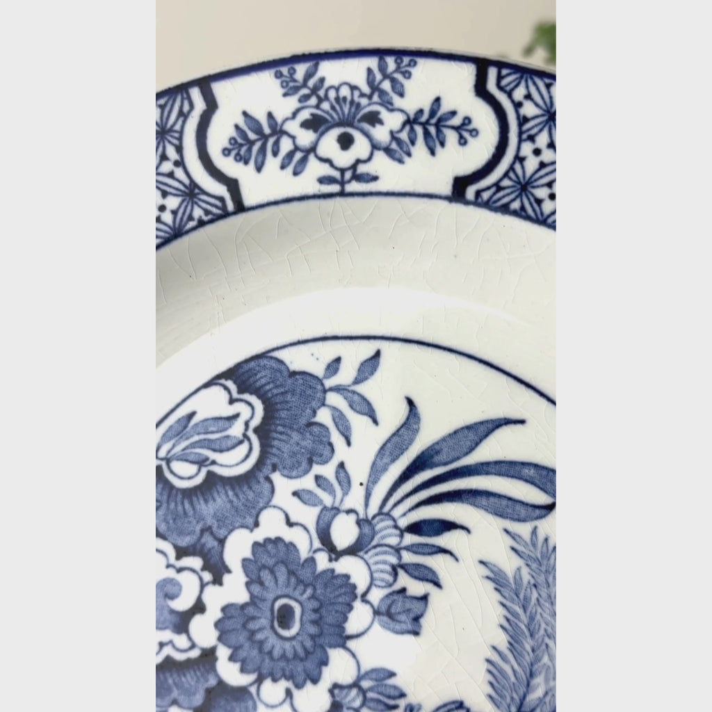 Video showing border and center of vintage Wood & Sons Yuan blue and white plate with bird, floral, and geometric decoration.