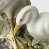 Close view of a vintage ceramic spill vase with two cranes, panning from the lower crane’s head up to the upper crane before pulling back to show the full vase