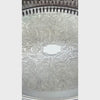 Closeup video of vintage oval silverplate gallery tray with a pierced railing, patterned raised rim, and elaborate floral scrollwork across the base.