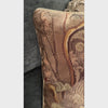 Close-up video of square wool needlepoint pillow depicting a white Westie seated on an ornate armchair, surrounded by warm olive, gold, pink, plum, and tan details.