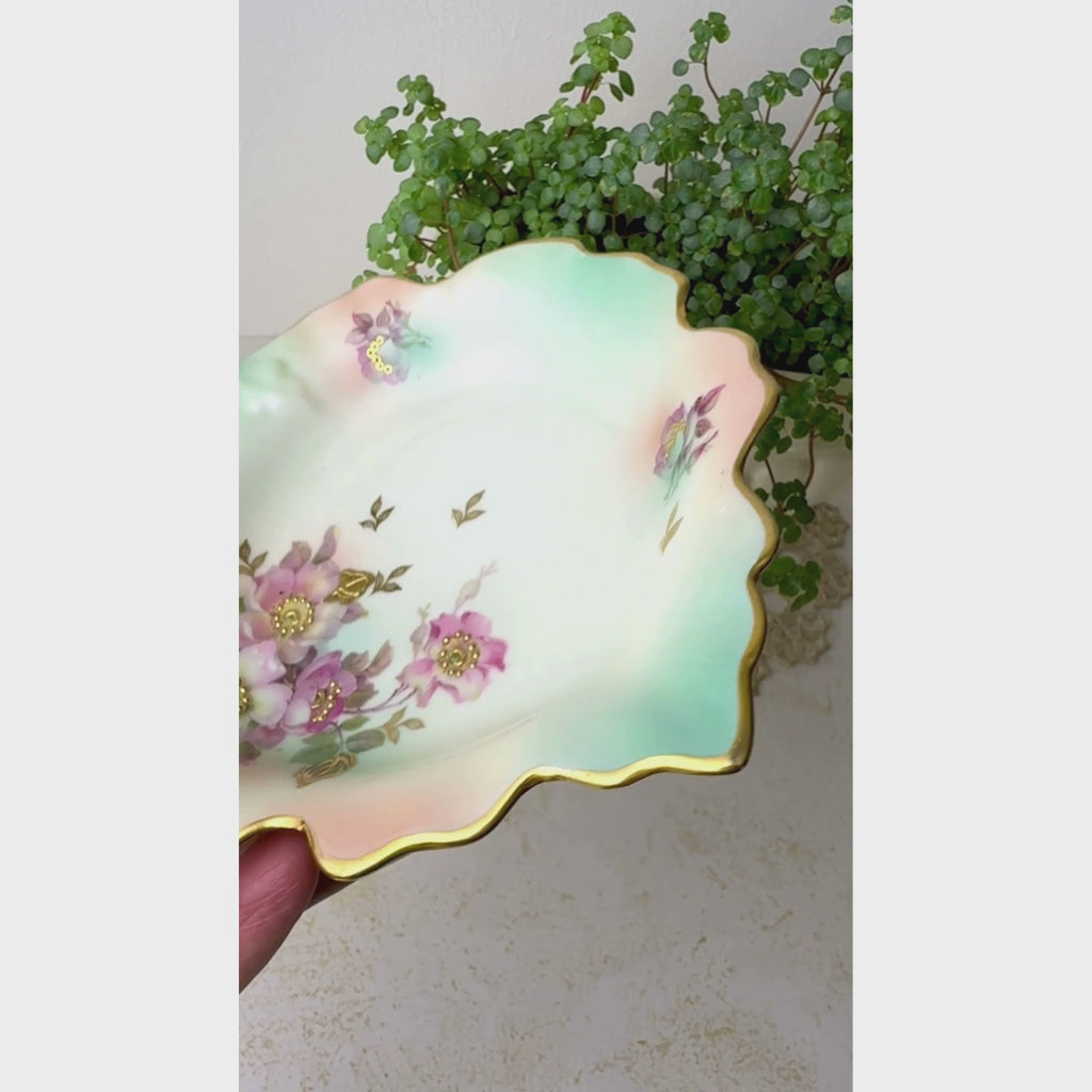 Video of vintage Schumann Arzberg porcelain trinket dish showing mauve florals, aqua shading, scalloped leaf form, and gold details.