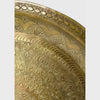 Vintage round brass tray panning the decorative surface close up along the rim and then to the center of the tray