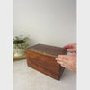 Antique wooden box with faux grain paint shown on a neutral backdrop as it is opened and tilted to display the interior