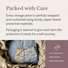 The Mauve Maven "Packed with Care" graphic showing a wrapped vintage parcel nestled in protective kraft paper with text about tailored packaging and eco-conscious, paper-based protective materials